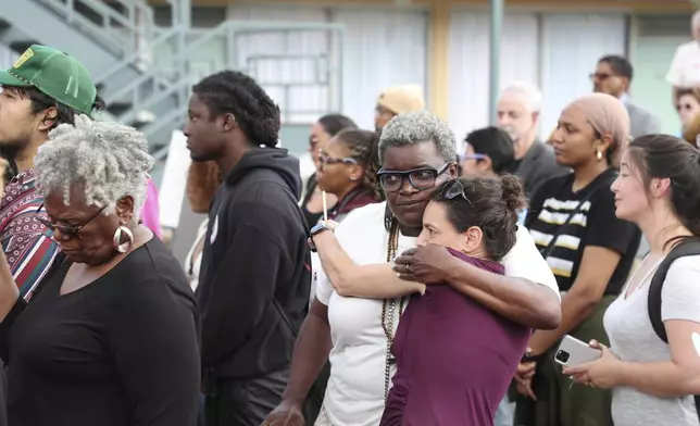 Tameka Greer, center left, and Dory Lerner, center right, embrace during a community rally in honor of Tyre Nichols, Thursday, May 8, 2025, in Memphis, Tenn. (AP Photo/Nikki Boertman)