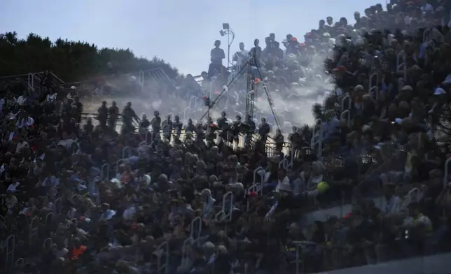 Spectators watch Italy's Jannik Sinner playing Norway's Casper Ruud, during their quarterfinal tennis match at the Italian Open, at the Foro Italico, in Rome, Thursday, May 15, 2025. (AP Photo/Alessandra Tarantino)