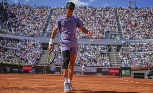 Spain's Carlos Alcaraz walks on the court during the semifinal tennis match against Italy's Lorenzo Musetti at the Italian Open, in Rome, Friday, May 16, 2025. (AP Photo/Andrew Medichini)