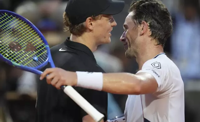 Italy's Jannik Sinner, left, greets Norway's Casper Ruud, at the end of their quarterfinal tennis match at the Italian Open, at the Foro Italico, in Rome, Thursday, May 15, 2025. (AP Photo/Alessandra Tarantino)