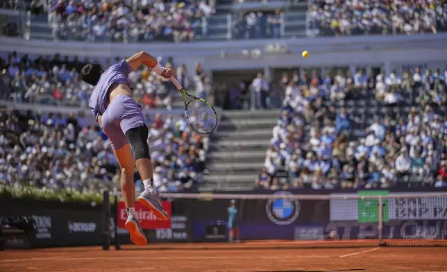 Spain's Carlos Alcaraz returns the ball to Italy's Lorenzo Musetti during their semifinal tennis match at the Italian Open, at the Foro Italico, in Rome, Friday, May 16, 2025. (AP Photo/Andrew Medichini)