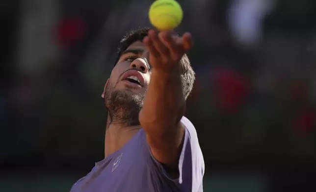 Spain's Carlos Alcaraz rserves the ball to Italy's Lorenzo Musetti during their semifinal tennis match at the Italian Open, in Rome, Friday, May 16, 2025. (AP Photo/Andrew Medichini)