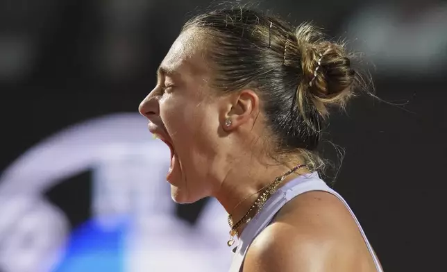 Aryna Sabalenka of Belarus reacts during a quarter-final tennis match against China's Qinwen Zheng at the Italian Open in Rome, Italy, Wednesday, May 14, 2025. (AP Photo/Alessandra Tarantino)