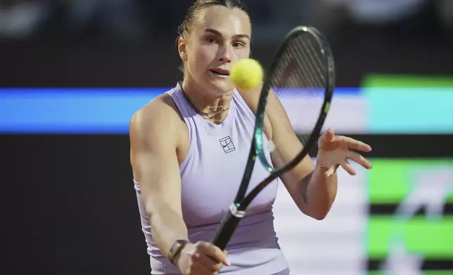 Aryna Sabalenka of Belarus retruns to China's Qinwen Zheng during a quarter-final tennis match at the Italian Open in Rome, Italy, Wednesday, May 14, 2025. (AP Photo/Alessandra Tarantino)