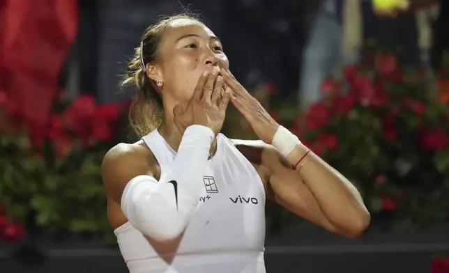 China's Qinwen Zheng celebrates after winning a quarter-final tennis match against Aryna Sabalenka of Belarus at the Italian Open in Rome, Italy, Wednesday, May 14, 2025. (AP Photo/Alessandra Tarantino)