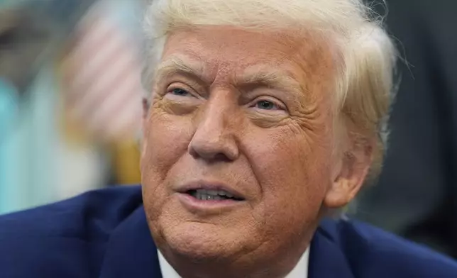 President Donald Trump speaks with reporters as he signs an executive order in the Oval Office of the White House, Friday, May 9, 2025, in Washington. (AP Photo/Alex Brandon)