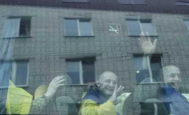 Ukrainian servicemen ride in a bus after returning from captivity in a POW exchange Ukraine, Tuesday, May 6, 2025. (AP Photo/Evgeniy Maloletka)