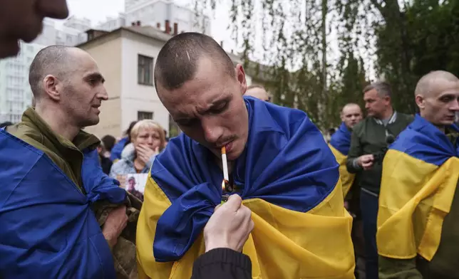 A Ukrainian soldier smokes a cigarette after returning from captivity in a POW exchange in Ukraine, Tuesday, May 6, 2025. (AP Photo/Evgeniy Maloletka)