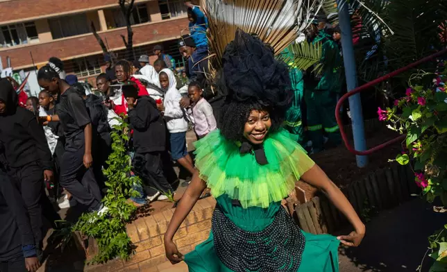 A performer participates in the annual Hillbrow street parade organized by the Windybrow Arts Centre and other local organisations in downtown Johannesburg, South Africa, Saturday, May 24, 2025. (AP Photo/Jerome Delay)