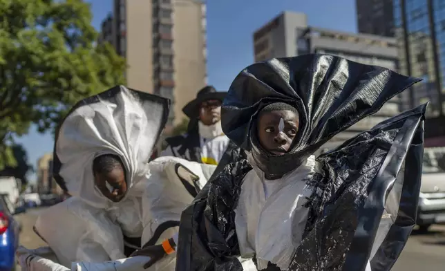 Children participate in the annual Hillbrow street parade organized by the Windybrow Arts Centre and other local organisations in downtown Johannesburg, South Africa, Saturday, May 24, 2025. (AP Photo/Jerome Delay)
