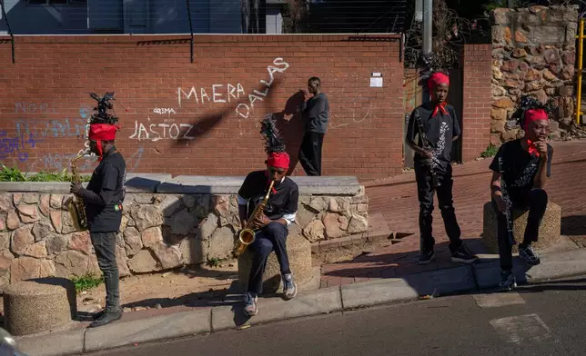 Musicians practice before the start of the annual Hillbrow street parade organized by the Windybrow Arts Centre and other local organisations in downtown Johannesburg, South Africa, Saturday, May 24, 2025. (AP Photo/Jerome Delay)