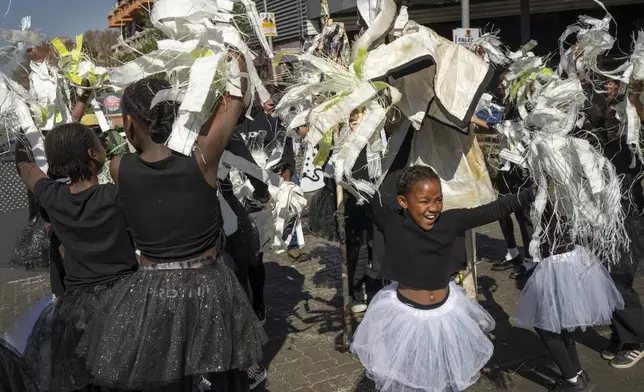Children participate in the annual Hillbrow street parade organized by the Windybrow Arts Centre and other local organisations in downtown Johannesburg, South Africa, Saturday, May 24, 2025. (AP Photo/Jerome Delay)