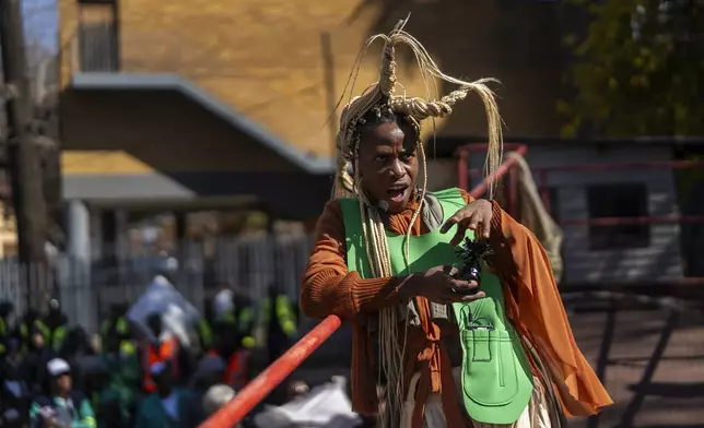 A performer participates in the annual Hillbrow street parade organized by the Windybrow Arts Centre and other local organisations in downtown Johannesburg, South Africa, Saturday, May 24, 2025. (AP Photo/Jerome Delay)