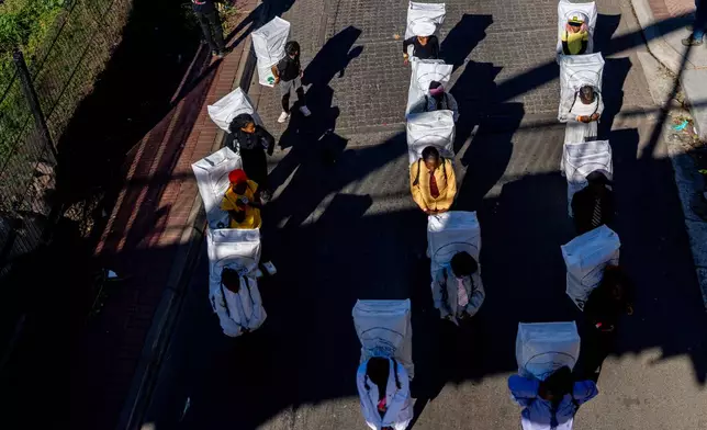 Children participates in the annual Hillbrow street parade organized by the Windybrow Arts Centre and other local organisations in downtown Johannesburg, South Africa, Saturday, May 24, 2025. (AP Photo/Jerome Delay)