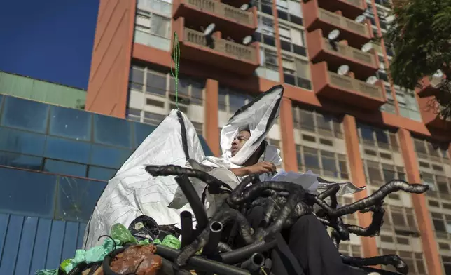 A performer participates in the annual Hillbrow street parade organized by the Windybrow Arts Centre and other local organisations in downtown Johannesburg, South Africa, Saturday, May 24, 2025. (AP Photo/Jerome Delay)