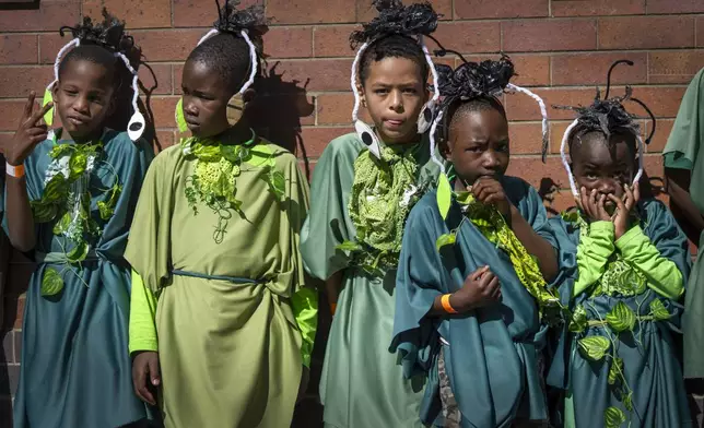 Children participate in the annual Hillbrow street parade organized by the Windybrow Arts Centre and other local organisations in downtown Johannesburg, South Africa, Saturday, May 24, 2025. (AP Photo/Jerome Delay)