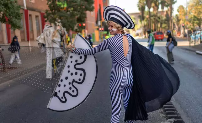 A performer participates in the annual Hillbrow street parade organized by the Windybrow Arts Centre and other local organisations in downtown Johannesburg, South Africa, Saturday, May 24, 2025. (AP Photo/Jerome Delay)