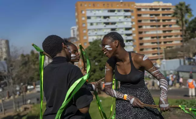 Residents participates in the annual Hillbrow street parade organized by the Windybrow Arts Centre and other local organisations in downtown Johannesburg, South Africa, Saturday, May 24, 2025. (AP Photo/Jerome Delay)