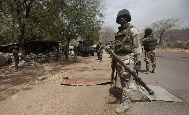 FILE - Nigerian soldiers man a checkpoint in Gwoza, northeast, Nigeria, April 8, 2015. (AP Photo/Lekan Oyekanmi, File)