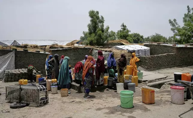 FILE- Women displaced from Boko Haram attacks fetch water from a borehole in Dikwa, north east Nigeria, April 29, 2025. (AP Photo/Sunday Alamba, File)
