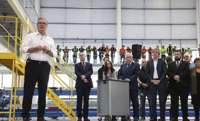 British Prime Minister Keir Starmer speaks to workers during a visit to Glass Futures in Saint Helens, Merseyside, England, Thursday May 29, 2025. (James Speakman/PA via AP)