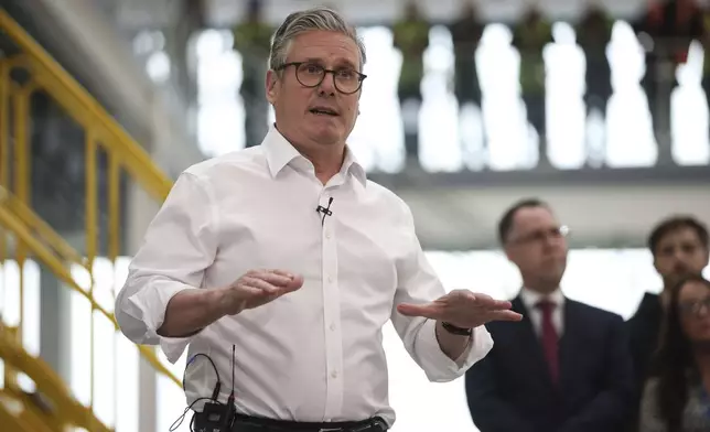 British Prime Minister Keir Starmer speaks to workers during a visit to Glass Futures in Saint Helens, Merseyside, England, Thursday May 29, 2025. (James Speakman/PA via AP)