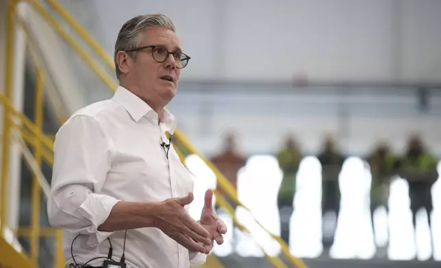 British Prime Minister Keir Starmer speaks to workers during a visit to Glass Futures in Saint Helens, Merseyside, England, Thursday May 29, 2025. (James Speakman/PA via AP)
