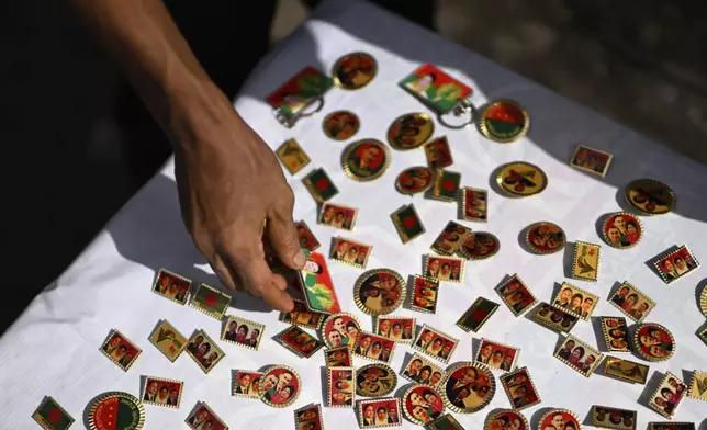 A street vendor sells badges of the Bangladesh Nationalist Party (BNP) leaders during a rally calling for a general election in December, in Dhaka, Bangladesh, Wednesday, May 28, 2025. (AP Photo/Mahmud Hossain Opu)