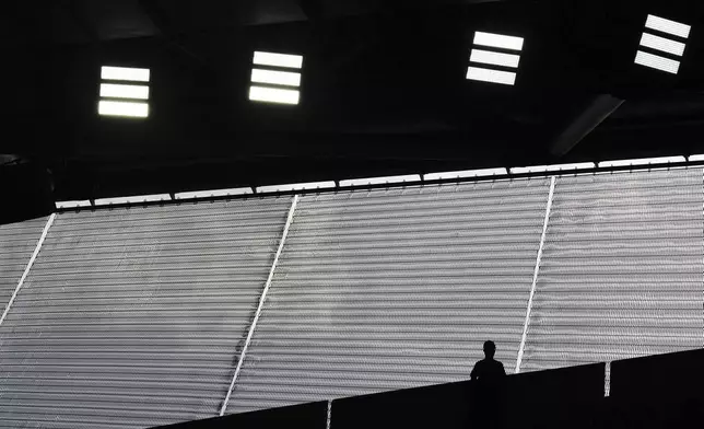 A fan watches from the top of the stands during a second-round match between Aryna Sabalenka of Belarus and Switzerland's Jil Teichmann during the French Tennis Open at the Roland-Garros stadium in Paris, Wednesday, May 28, 2025. (AP Photo/Lindsey Wasson)