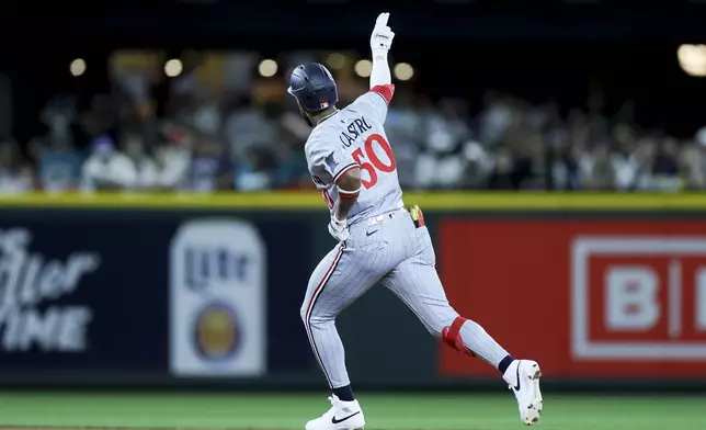 Minnesota Twins' Willi Castro celebrates while running the bases after hitting a two-run home run that scored Ty France during the ninth inning of a baseball game against the Seattle Mariners Friday, May 30, 2025, in Seattle. (AP Photo/Ryan Sun)