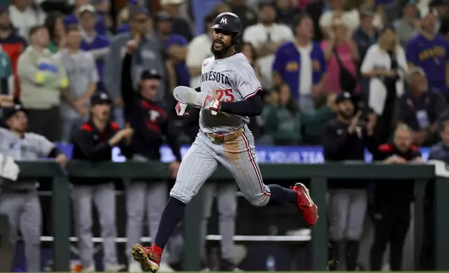 Minnesota Twins' Byron Buxton runs home for the game-tying run off a single hit by designated hitter Trevor Larnach during the ninth inning of a baseball game against the Seattle Mariners Friday, May 30, 2025, in Seattle. (AP Photo/Ryan Sun)