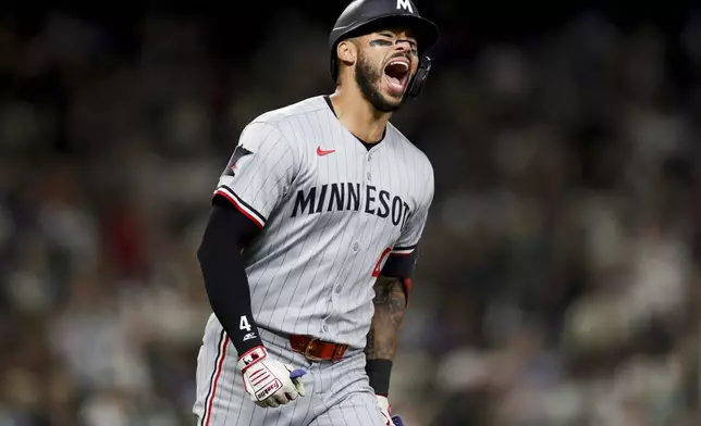 Minnesota Twins' Carlos Correa celebrates after hitting a go-ahead two-run home run during the 10th inning of a baseball game against the Seattle Mariners Friday, May 30, 2025, in Seattle. DaShawn Keirsey Jr. also scored. (AP Photo/Ryan Sun)