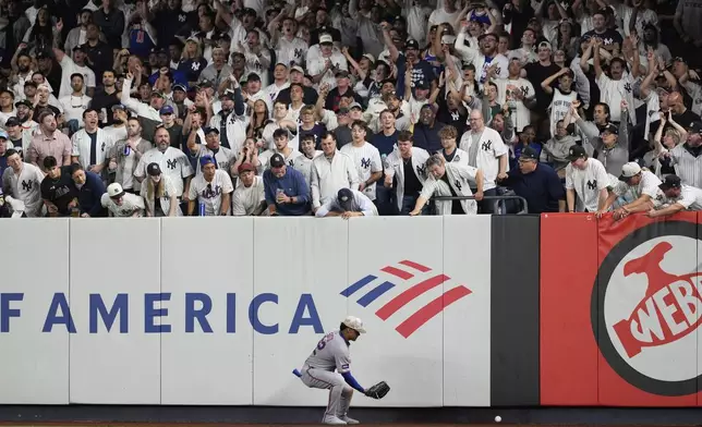 Fans watch as New York Mets outfielder Juan Soto plays a ball off the wall during the fourth inning of a baseball game Friday, May 16, 2025, in New York. (AP Photo/Seth Wenig)