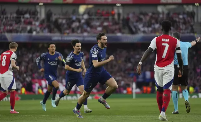 PSG players celebrate after their teammate Ousmane Dembele scored his side's opening goal during the Champions League semifinal first leg soccer match between Arsenal and Paris Saint-Germain at Emirates Stadium in London, England, Tuesday, April 29, 2025. (AP Photo/Kirsty Wigglesworth)