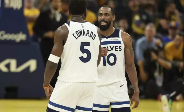 Minnesota Timberwolves guard Anthony Edwards (5) celebrates with guard Mike Conley (10) during the second half of Game 4 in the Western Conference semifinals of the NBA basketball playoffs against the Golden State Warriors, Monday, May 12, 2025, in San Francisco. (AP Photo/Jed Jacobsohn)