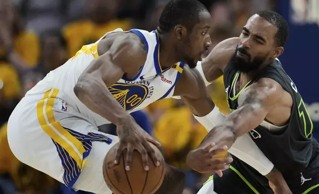 Minnesota Timberwolves guard Mike Conley, right, tries to knock the ball away from Golden State Warriors forward Jonathan Kuminga during the second half of Game 3 of an NBA basketball second-round playoff series Saturday, May 10, 2025, in San Francisco. (AP Photo/Godofredo A. Vásquez)
