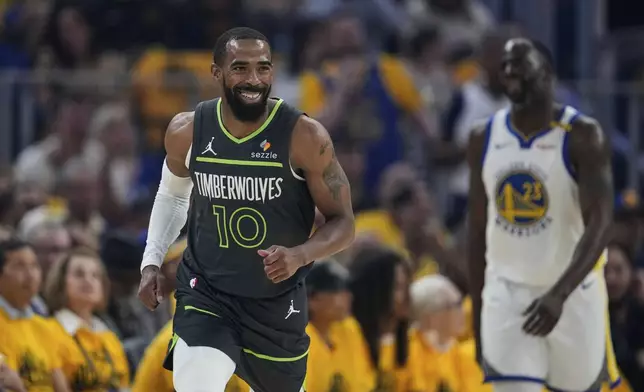 Minnesota Timberwolves guard Mike Conley smiles after making a 3-point basket during the first half of Game 3 of an NBA basketball second-round playoff series against the Golden State Warriors, Saturday, May 10, 2025, in San Francisco. (AP Photo/Godofredo A. Vásquez)