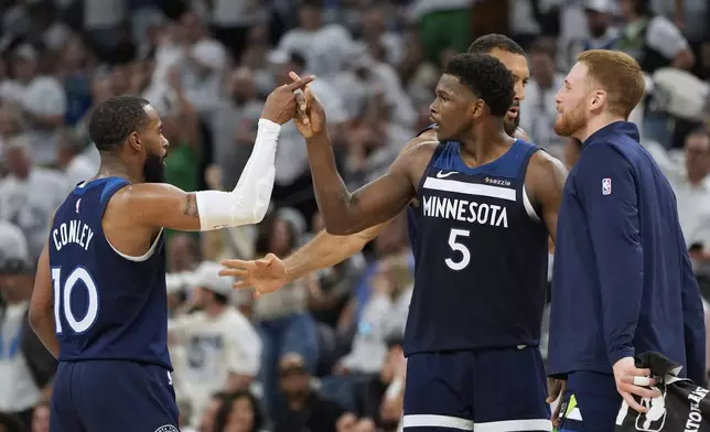 Minnesota Timberwolves guard Mike Conley (10) and Minnesota Timberwolves guard Anthony Edwards (5) celebrate after Conley scores during the first half of Game 5 of an NBA basketball second-round playoff series against the Golden State Warriors, Wednesday, May 14, 2025, in Minneapolis. (AP Photo/Abbie Parr)