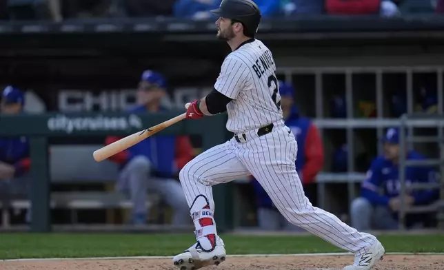 Chicago White Sox designated hitter Andrew Benintendi hits a two-run double during the sixth inning of a baseball game against the Texas Rangers, Saturday, May 24, 2025, in Chicago. (AP Photo/Erin Hooley)