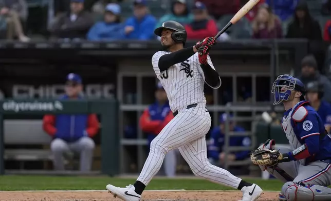 Chicago White Sox's Lenyn Sosa (50) hits a three-run double during the sixth inning of a baseball game against the Texas Rangers, Saturday, May 24, 2025, in Chicago. (AP Photo/Erin Hooley)