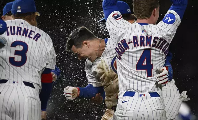 Chicago Cubs' Matt Shaw, center, celebrates with teammates after hitting a walk-off single to defeat the Colorado Rockies in the eleventh inning of a baseball game Tuesday, May 27, 2025, in Chicago. (AP Photo/Paul Beaty)