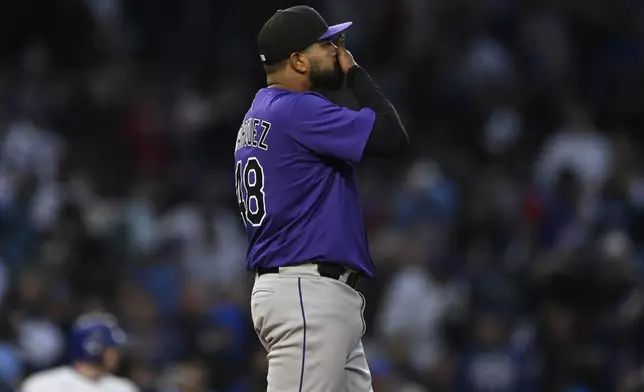 Colorado Rockies starting pitcher German Marquez reacts after giving up an RBI single to Chicago Cubs' Seiya Suzuki during the third inning of a baseball game Tuesday, May 27, 2025, in Chicago. (AP Photo/Paul Beaty)