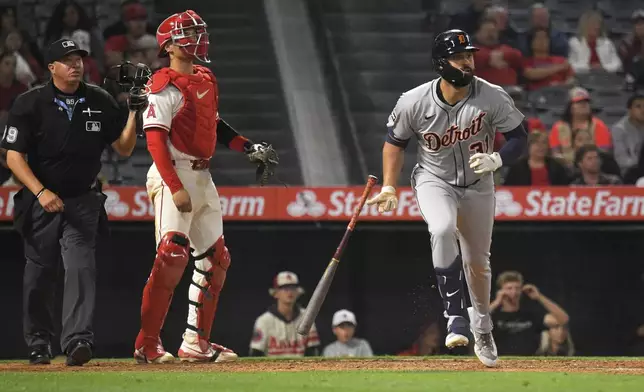 Detroit Tigers' Riley Greene, right, heads to first for a solo home run as Los Angeles Angels catcher Logan O'Hoppe watches during the ninth inning of a baseball game Friday, May 2, 2025, in Anaheim, Calif. (AP Photo/Mark J. Terrill)