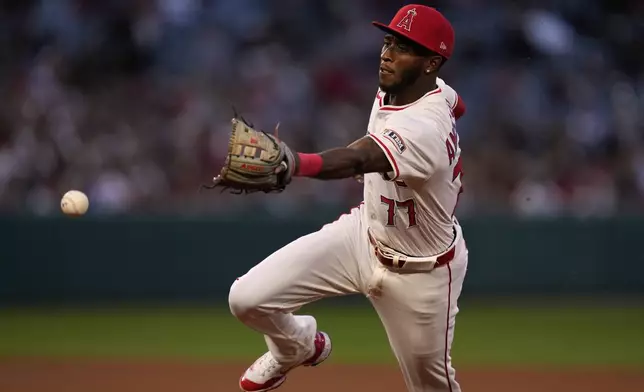 Los Angeles Angels second baseman Tim Anderson overthrows the ball to first, allowing Detroit Tigers' Dillon Dingler to first during the fourth inning of a baseball game Friday, May 2, 2025, in Anaheim, Calif. (AP Photo/Mark J. Terrill)