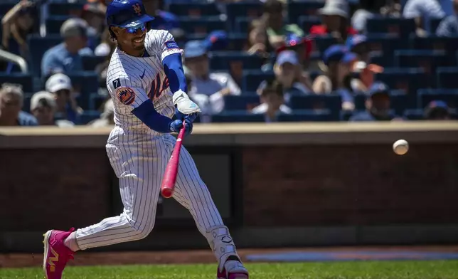 New York Mets infielder Francisco Lindor (12) bats during the sixth inning of the baseball game against the Chicago Cubs, Sunday, May 11, 2025, in New York. (AP Photo/Angelina Katsanis)