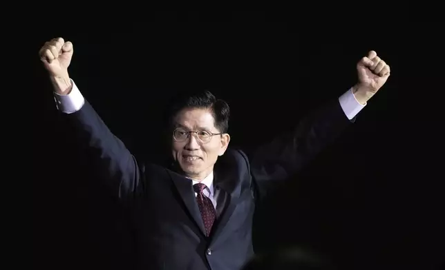 South Korea's former Labor Minister Kim Moon Soo raises his hands as he arrives to attend the People Power Party's convention in Goyang, South Korea, Saturday, May 3, 2025. (AP Photo/Ahn Young-joon)