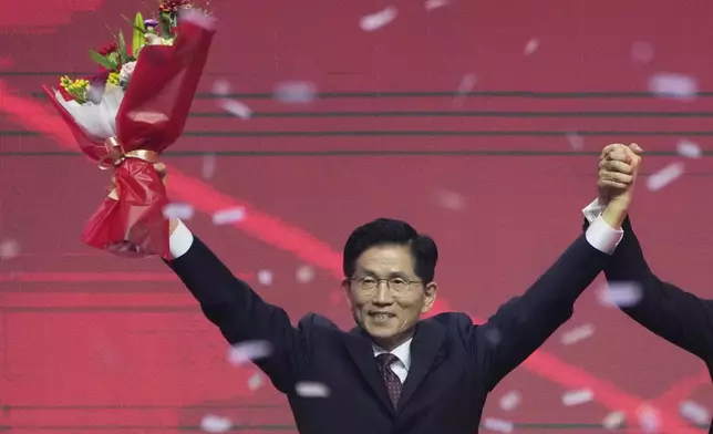 South Korea's former Labor Minister Kim Moon Soo celebrates after winning the nomination as the presidential election candidate during the People Power Party's convention in Goyang, South Korea, Saturday, May 3, 2025. (AP Photo/Ahn Young-joon)