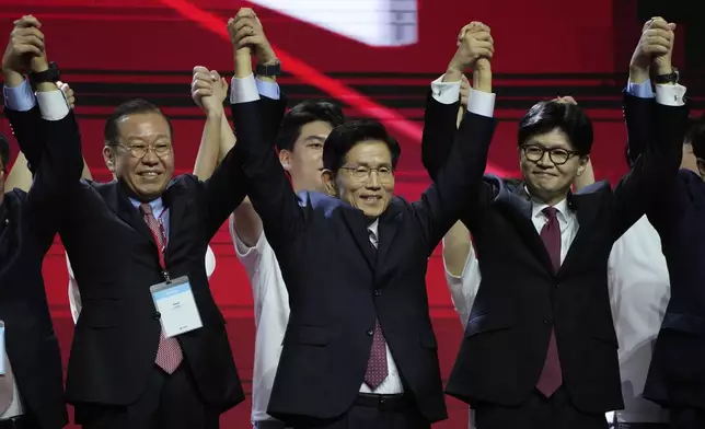 South Korea's former Labor Minister Kim Moon Soo, center, celebrates after winning the nomination as the presidential election candidate during the People Power Party's convention in Goyang, South Korea, Saturday, May 3, 2025. (AP Photo/Ahn Young-joon)