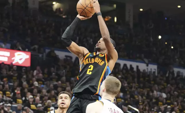 Oklahoma City Thunder's Shai Gilgeous-Alexander (2) shoots as Denver Nuggets' Christian Braun, front, and Michael Porter Jr., rear, defend in the second half of Game 2 in the conference semifinals of the NBA basketball playoffs, Wednesday, May 7, 2025, in Oklahoma City. (AP Photo/Kyle Phillips)