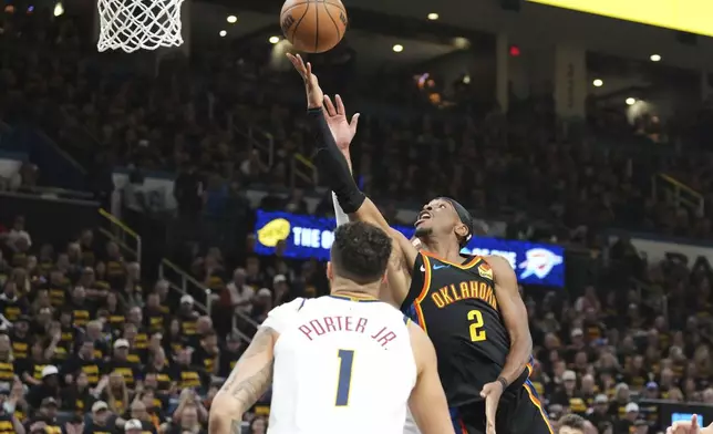 Oklahoma City Thunder guard Shai Gilgeous-Alexander (2) takes a shot as Denver Nuggets' Michael Porter Jr. (1) defends in the second half of Game 2 in the conference semifinals of the NBA basketball playoffs, Wednesday, May 7, 2025, in Oklahoma City. (AP Photo/Kyle Phillips)